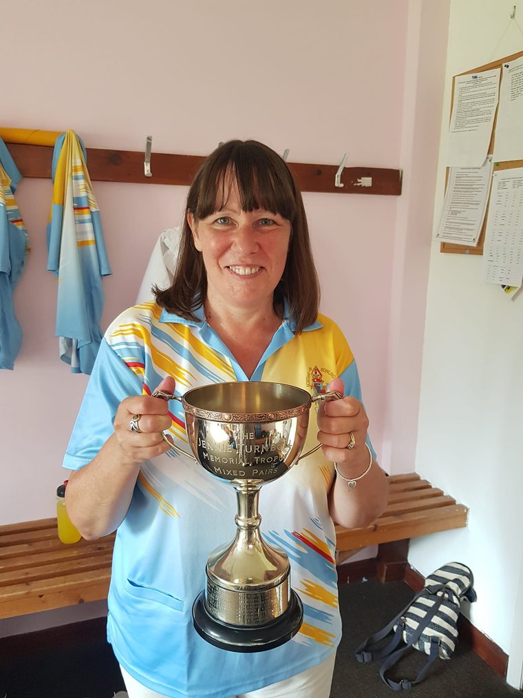 Jackie from Green Apps holding a bowls trophy at the club